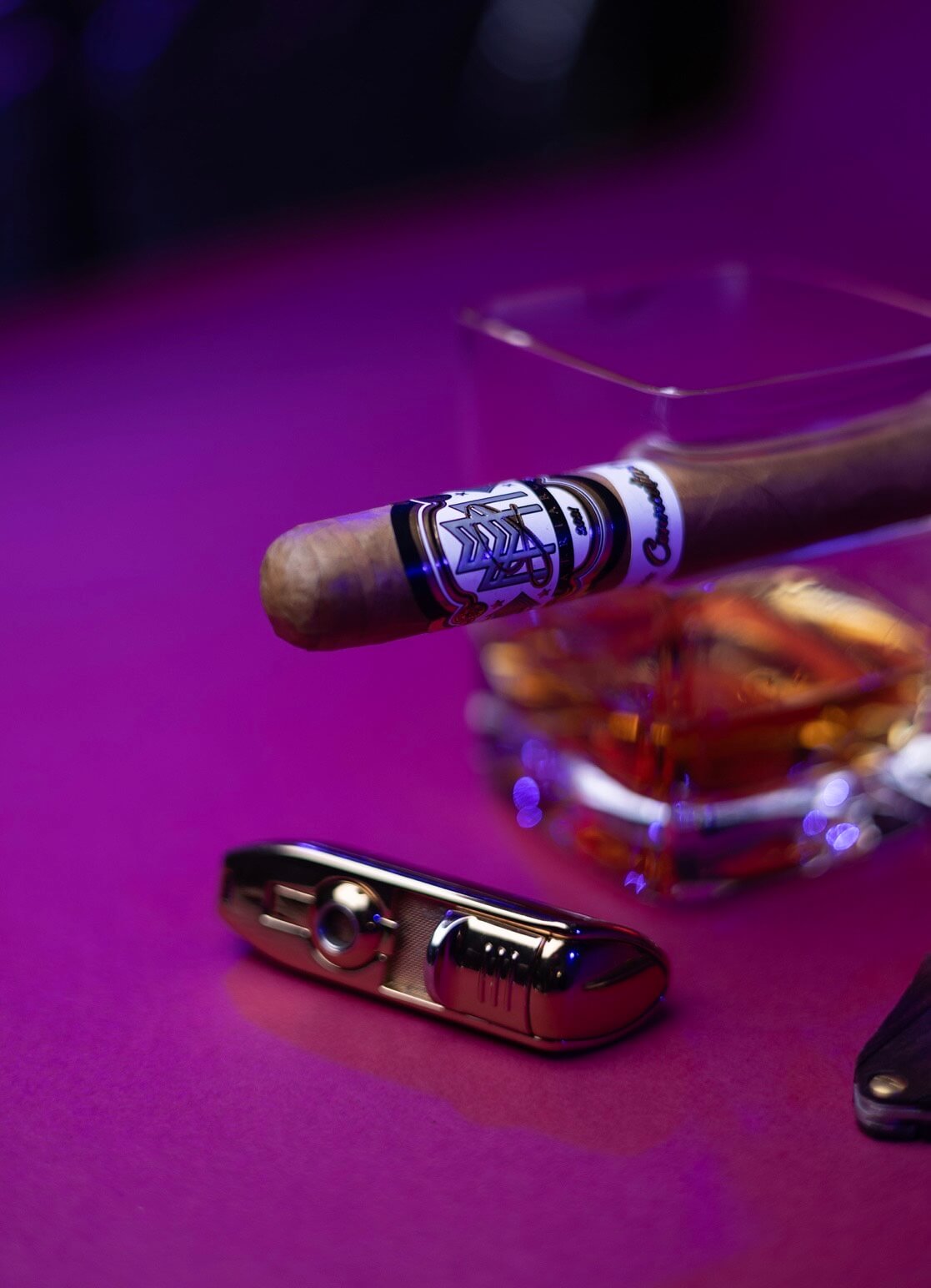 JM Patriarch cigar with a cutter and lighter